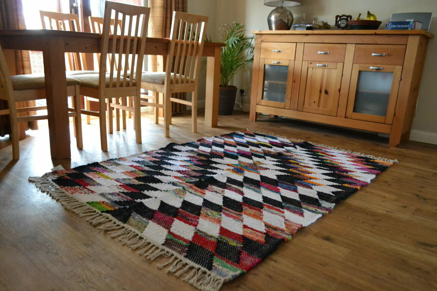 Variegated rug on a wooden floor