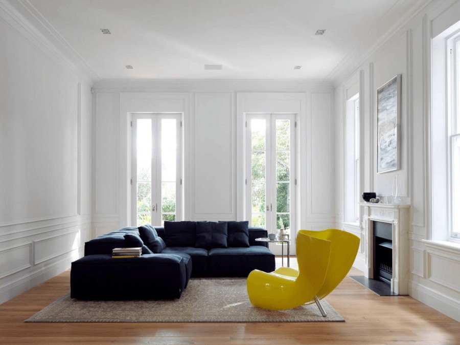 Bright yellow armchair in a white living room