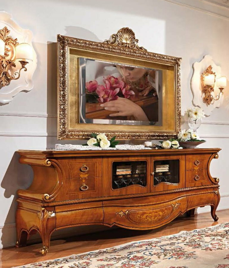 TV in a carved frame on a wooden chest of drawers
