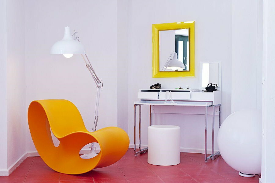 Yellow plastic armchair in a white room