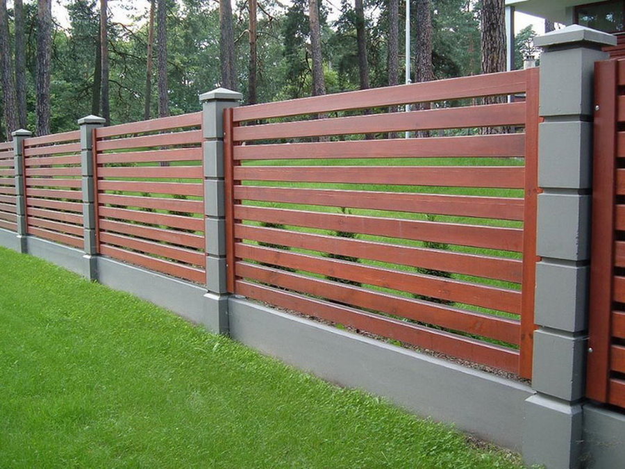 Brown board on gray fence poles