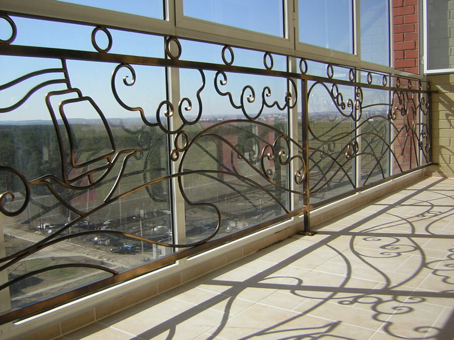 Forged railings on the loggia with French-style windows