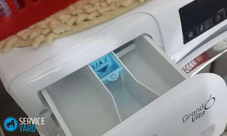 How do I clean the powder tray in the washing machine?