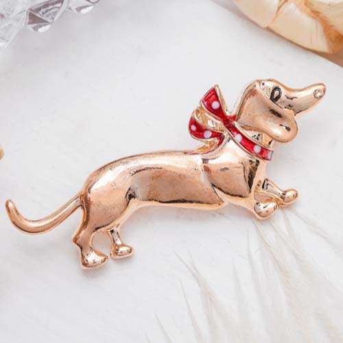 Brooch Dachshund with a bow, color red in gold