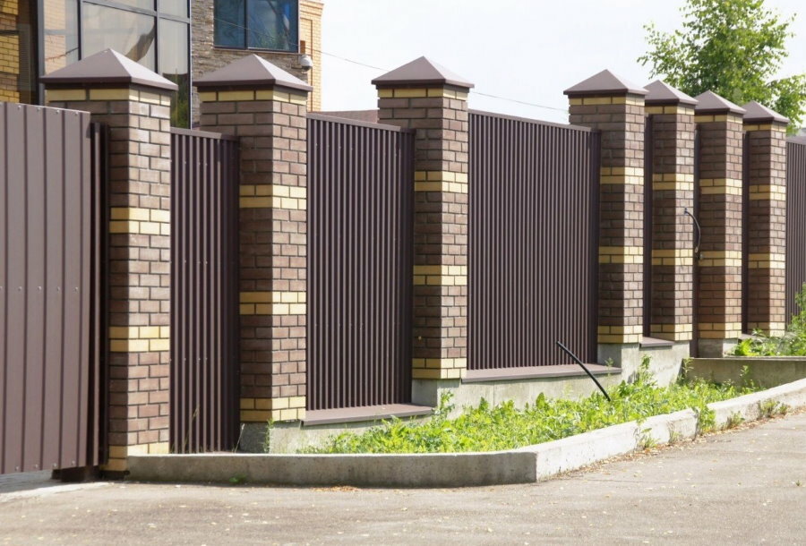 Deaf fence made of profiled sheet on brick columns