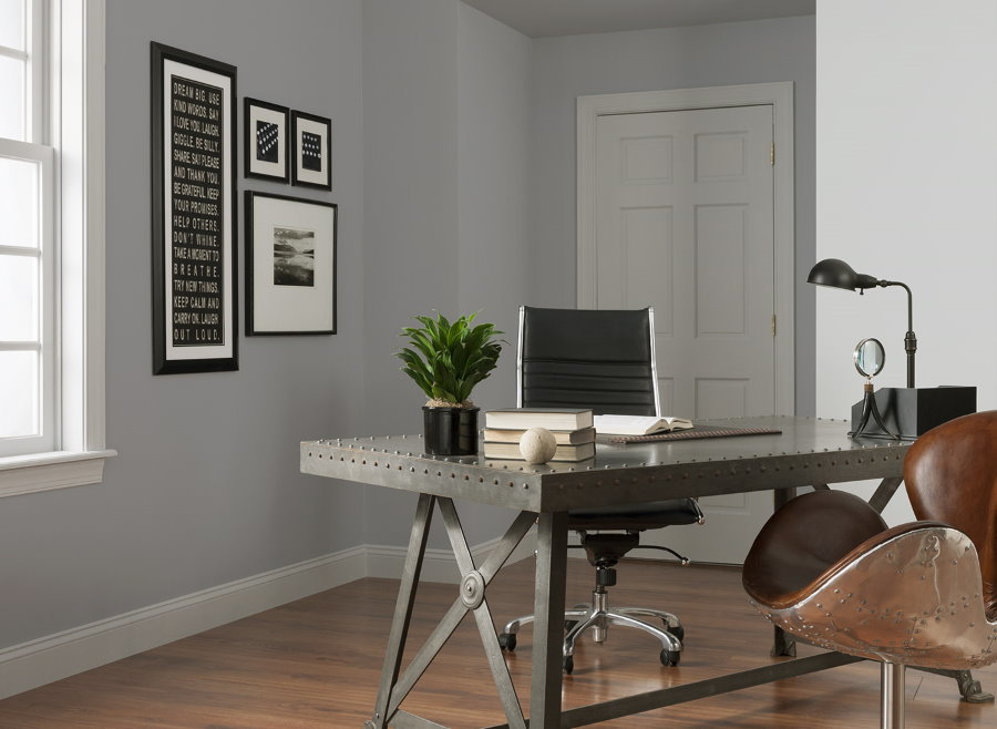 Metal table in a home office with gray walls