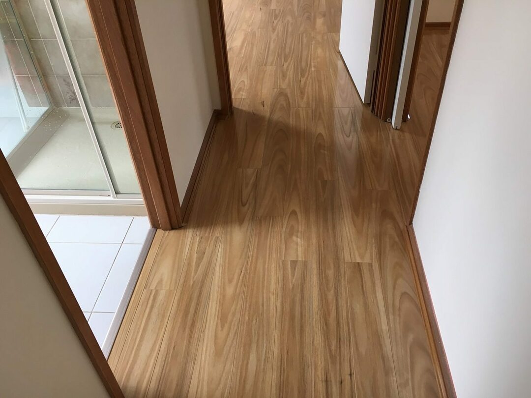 Narrow apartment corridor with laminated flooring