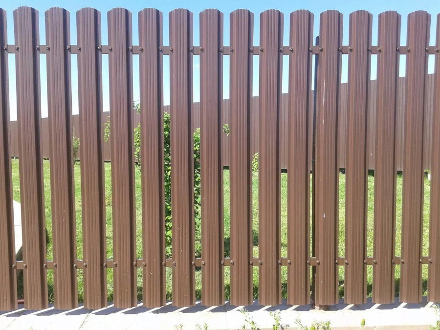 Brown fence of galvanized picket