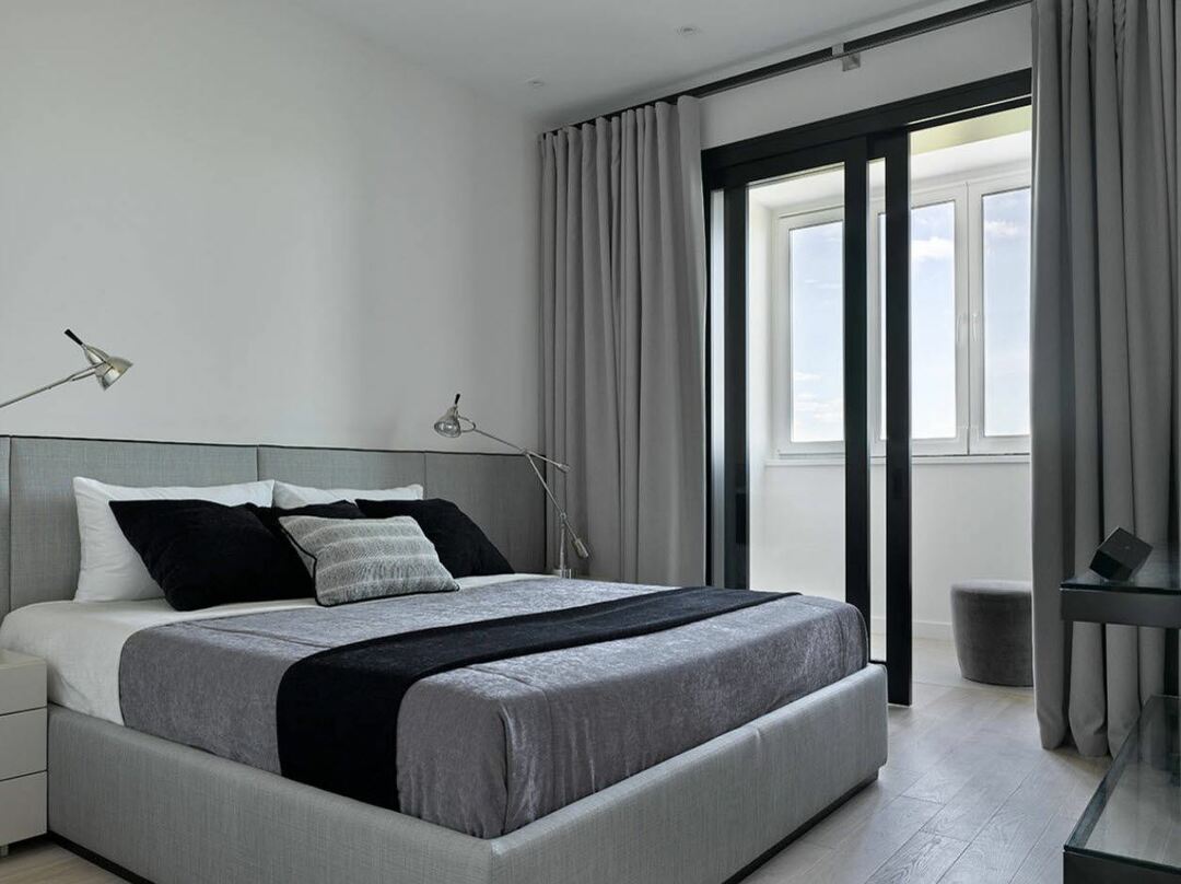 Black sliding doors in the bedroom with a balcony