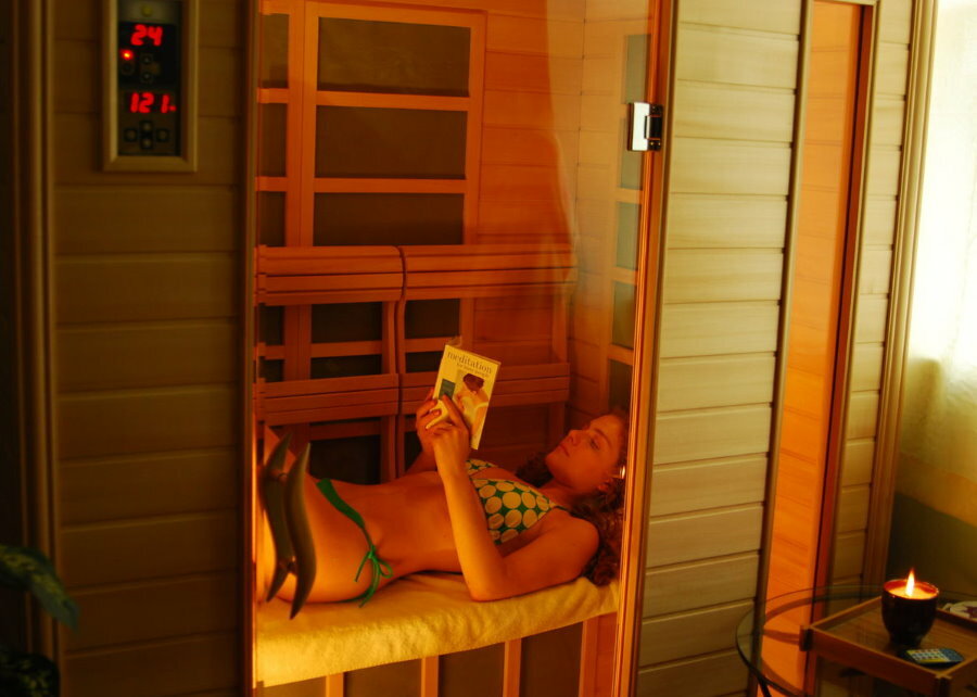Mädchen in einer kompakten Sauna auf der Loggia der Wohnung