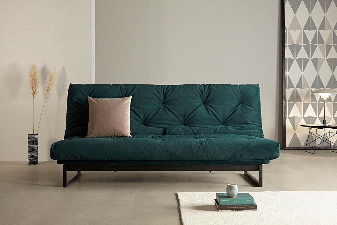 Dark green sofa with thin legs