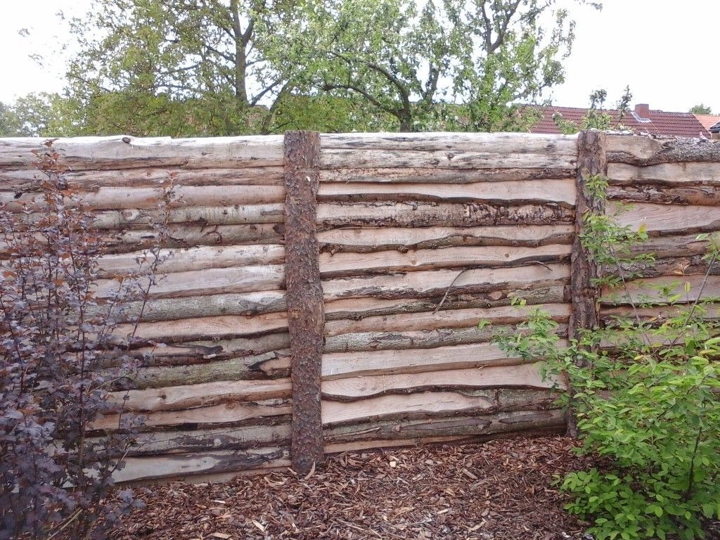 Original slab fence with remnants of bark