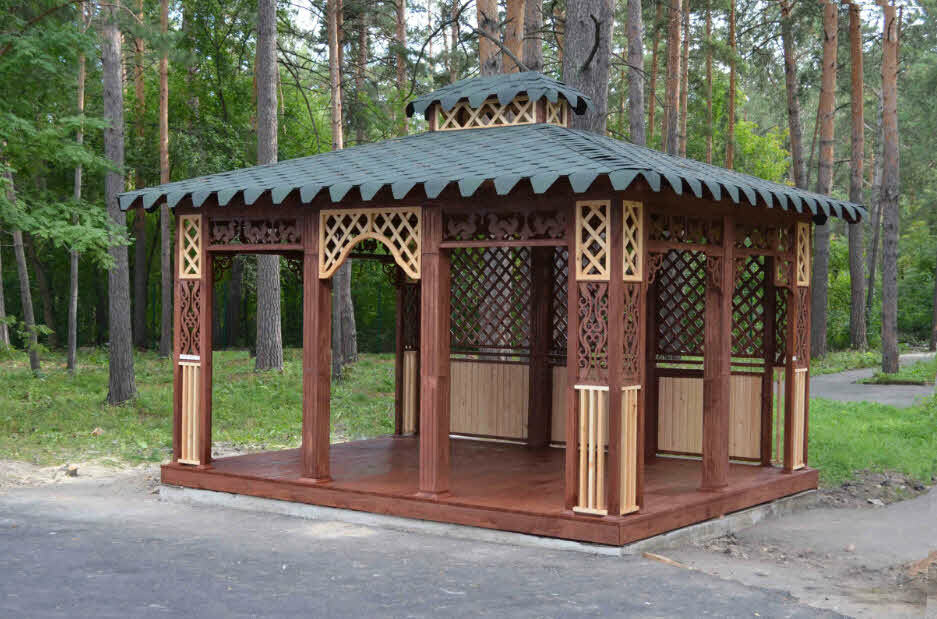 Square gazebo made of wood with soft tiles on the roof