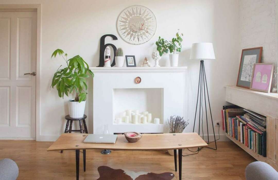White decorative fireplace with candles inside