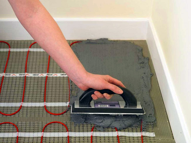 De keuze van lijm voor het leggen van tegels op een warme vloer: variëteit, kenmerken, fabrikanten