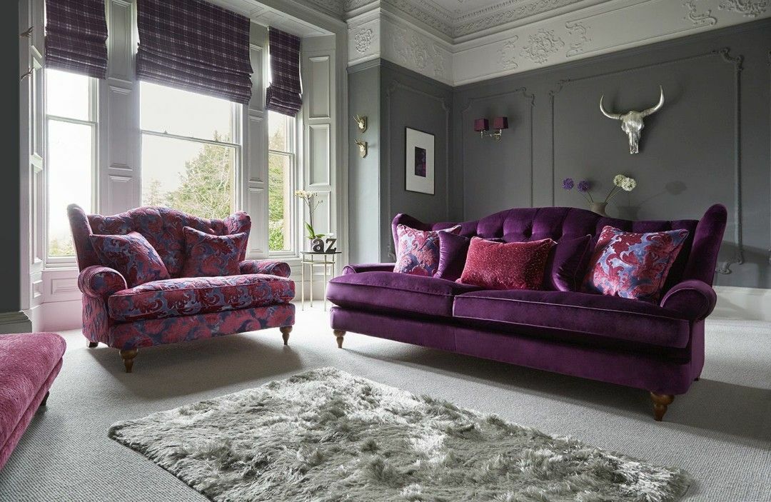 Gray wall decoration in a hall with a purple sofa