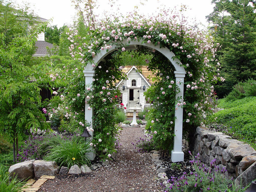 White wood arch over gravel path