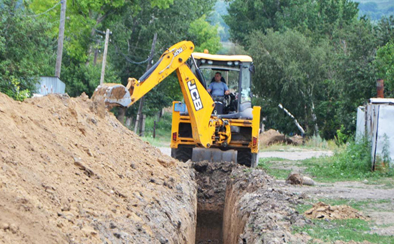An excavator digs a pit