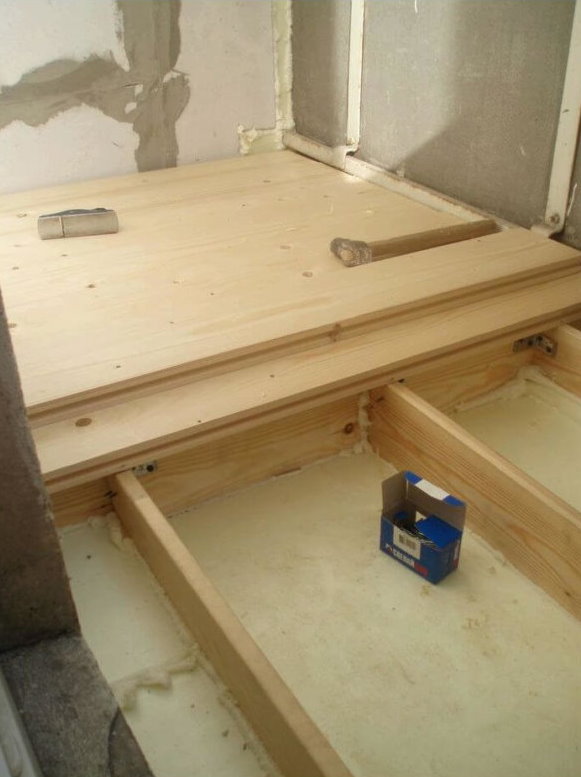 Installation of a wooden frame under the threshold on the balcony