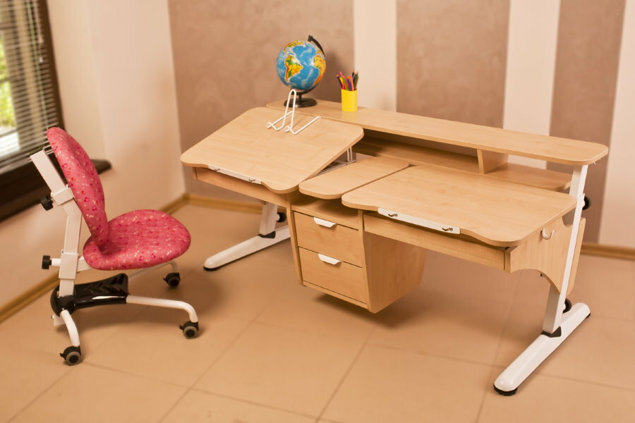 School desk-transformer in the room of schoolchildren of different ages