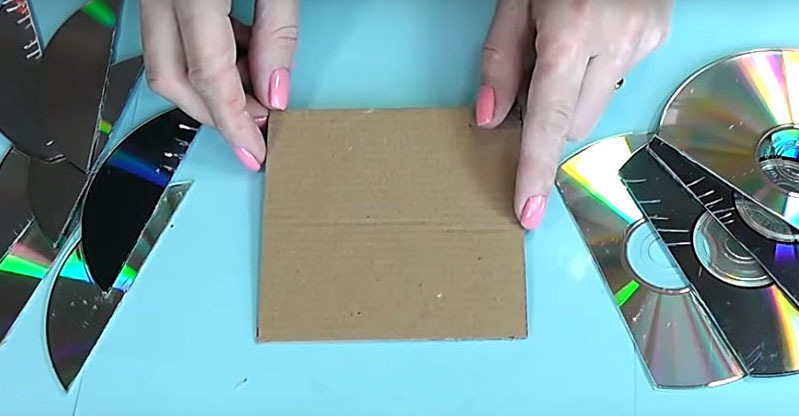 Bereiten Sie ein Stück Pappe vor, das dem Durchmesser der Scheibe entspricht. Schneiden Sie die Scheiben so, dass Sie mehrere Halbkreise erhalten und die Schnittbreite der Seite des Quadrats entspricht