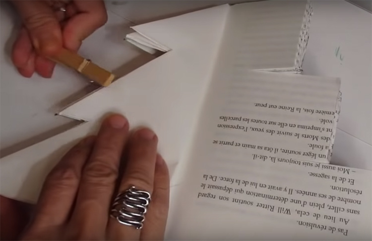 It is necessary to bend all three tiers on the page in this way. So that the book does not interfere with you and does not open constantly during work, fasten the folded sheets with a clothespin or press down with something heavy