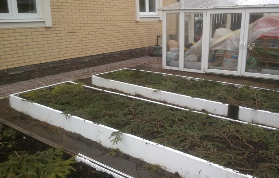 White beds of PVC window sills in front of a brick house