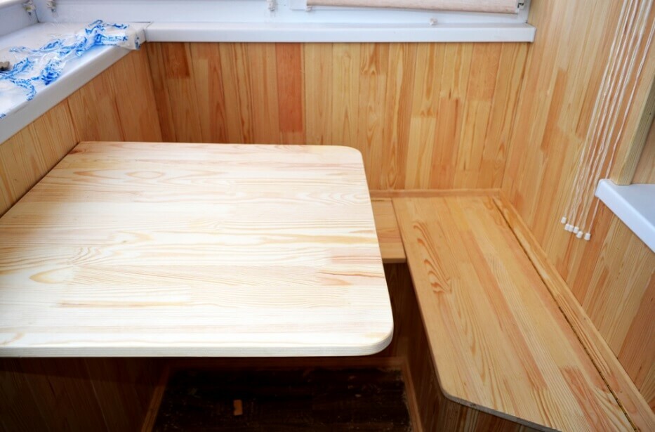 Folding table by the bench with wood trim