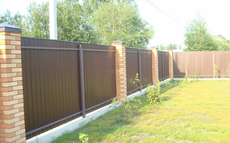 Solid corrugated fence with brick pillars
