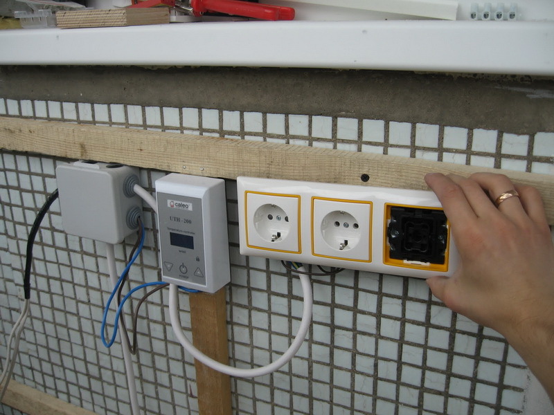 Installation of sockets for the sauna on the wall of the loggia