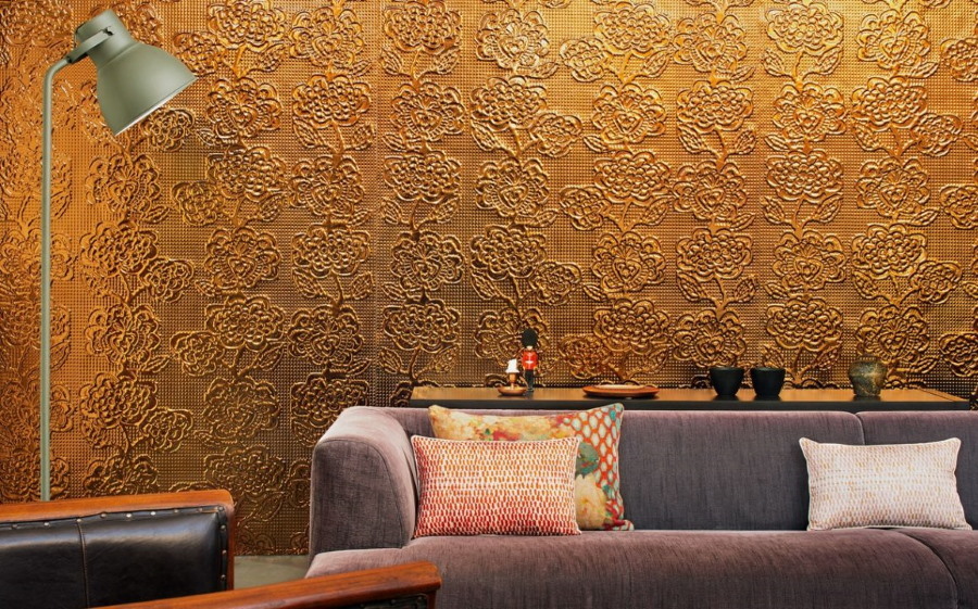 Wall with metallic wallpaper behind the back of the sofa