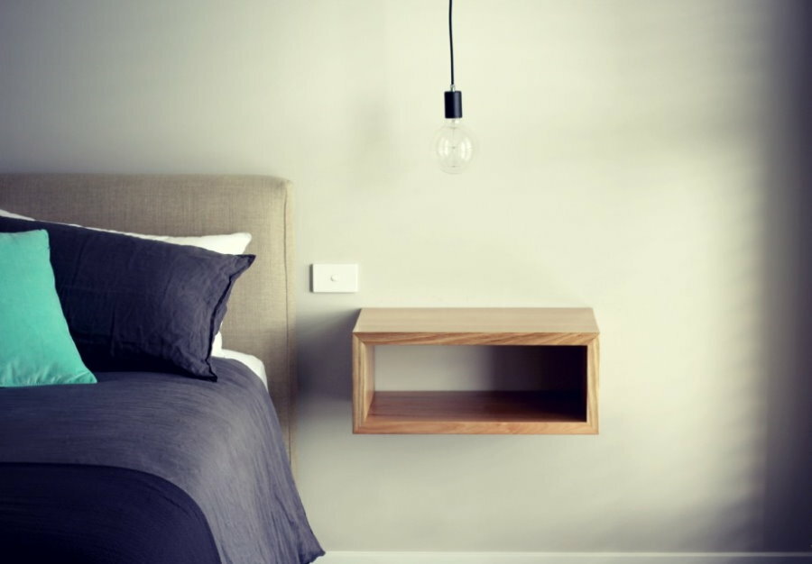 Hanging shelf on the bed in the bedroom