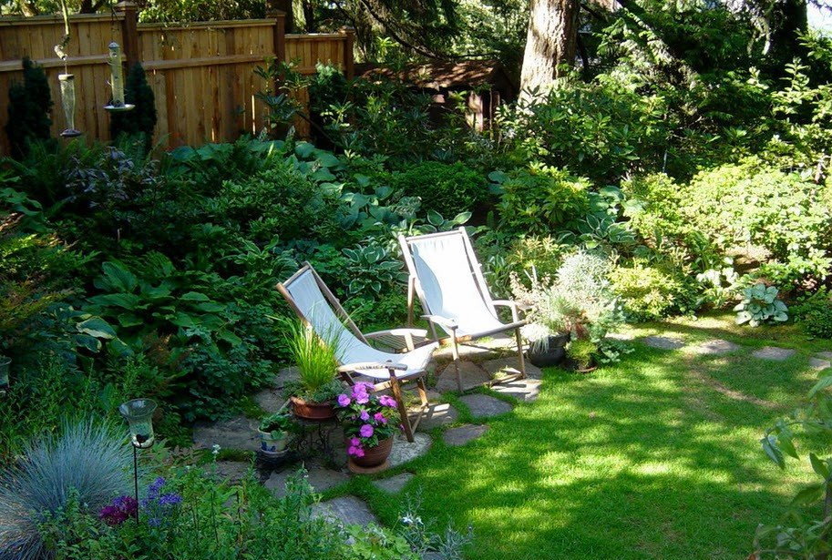 Garden deck chairs in a secluded corner of a garden site