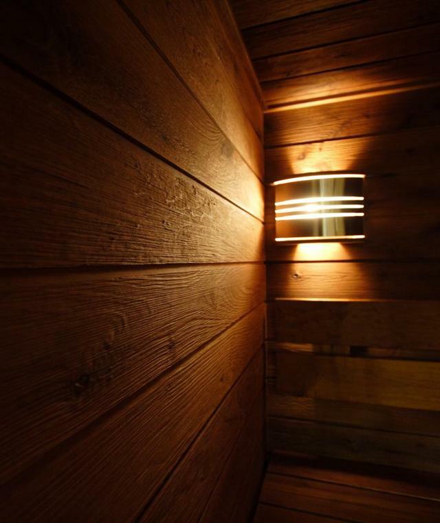 Special lamp on the wooden wall of the sauna