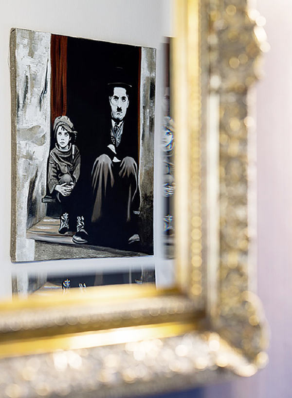 A pencil sketch of Charlie Chaplin was hung in the hall opposite the mirror.