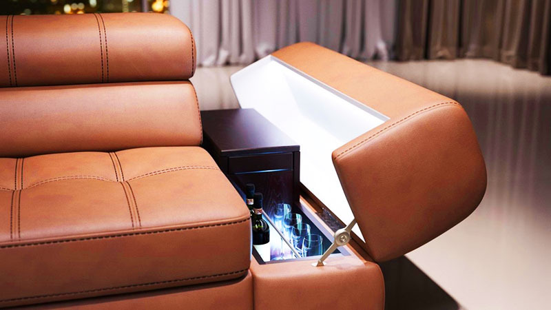 These bars have a retractable mechanism and easily roll out of the armrests or backs of sofas. It won't fit more than two or three bottles and a couple of glasses.