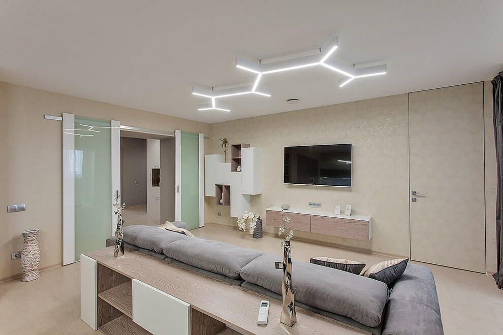 Linear lamps on the white ceiling of the living room