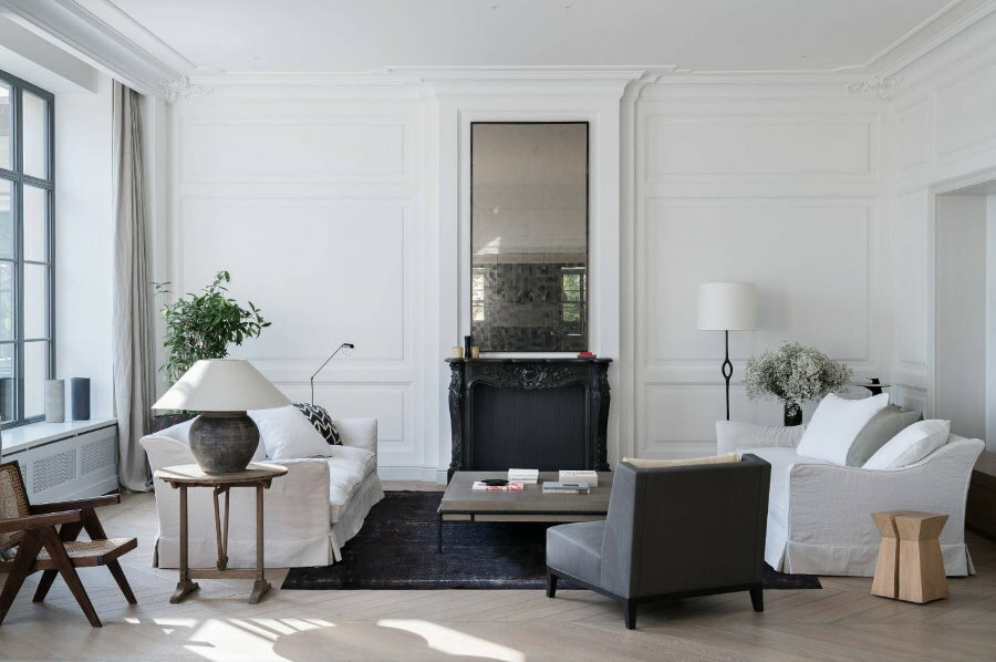 Narrow mirror above the fireplace in the white living room