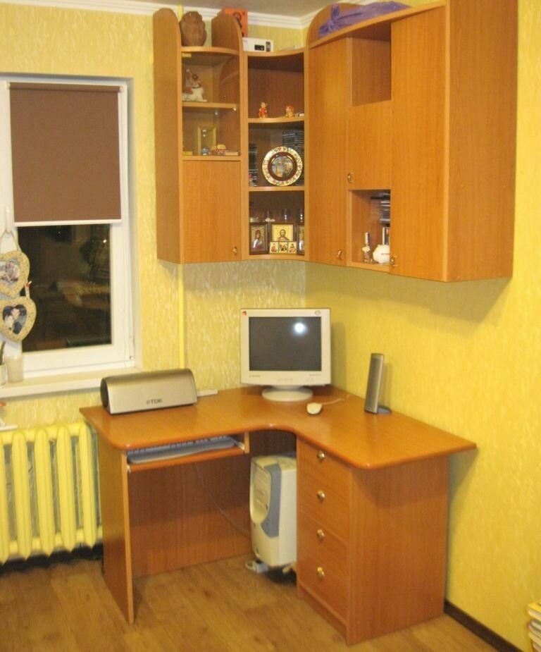 Workplace of a teenager in front of a window of a small room