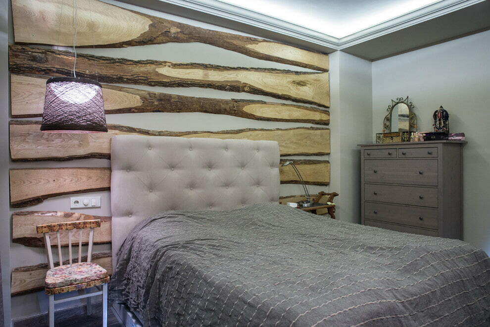 Wandtafeldekor über dem Bett in einem grauen Schlafzimmer