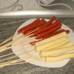 Sausage and cheese sticks is placed on skewers