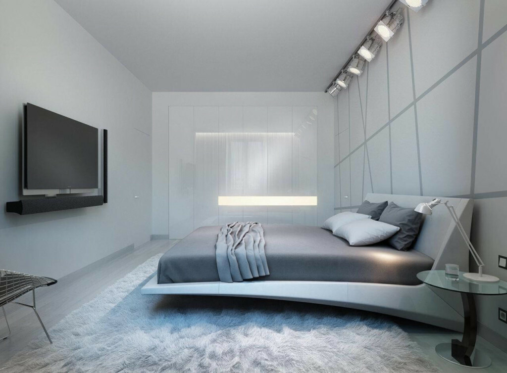 Snygg säng i ett grått sovrum i högteknologisk stil