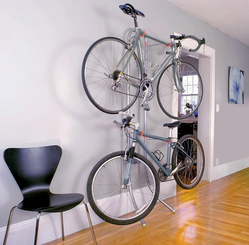 Two bicycles are secured against the wall