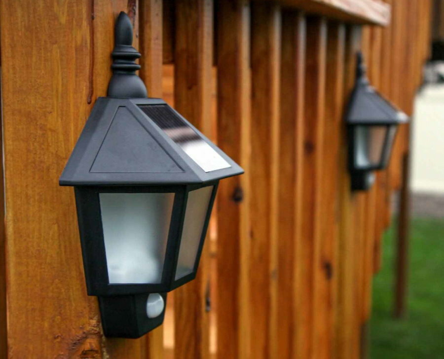 Lámpara solar con sensor de movimiento en una valla de madera