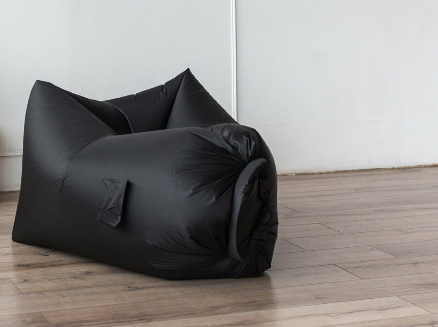 Black inflatable pouf on the floor of the hallway