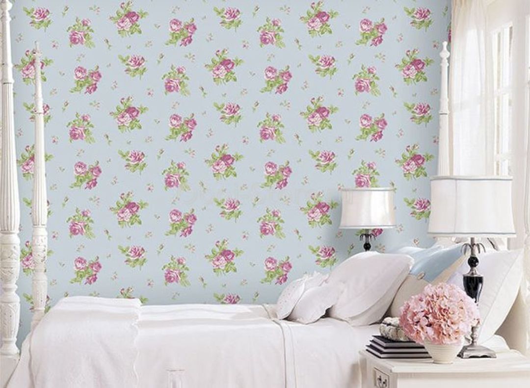 Small flowers on the wallpaper behind the bed girl