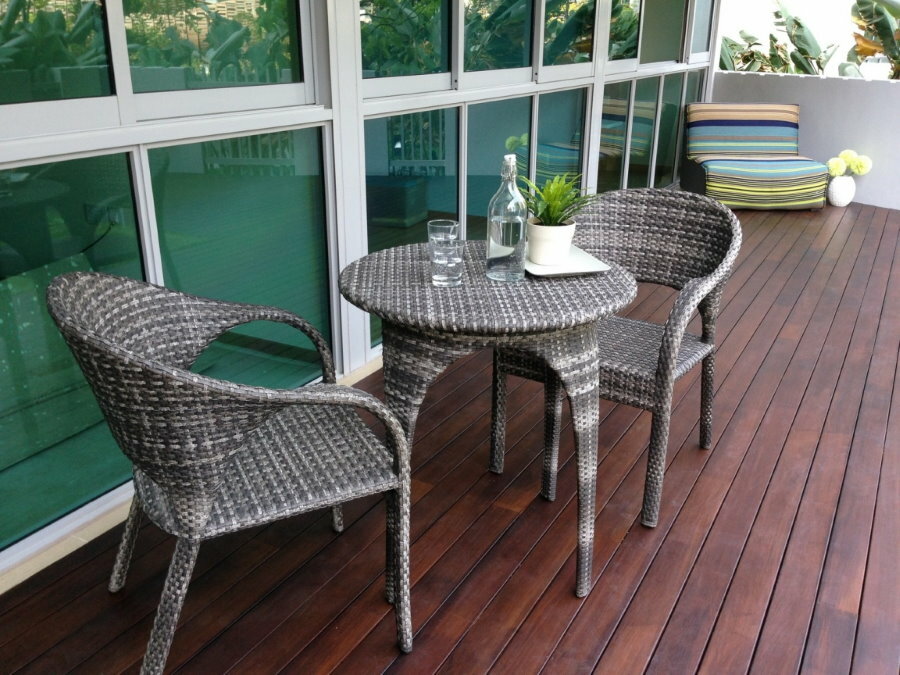 Rattan table on the balcony with wooden floor