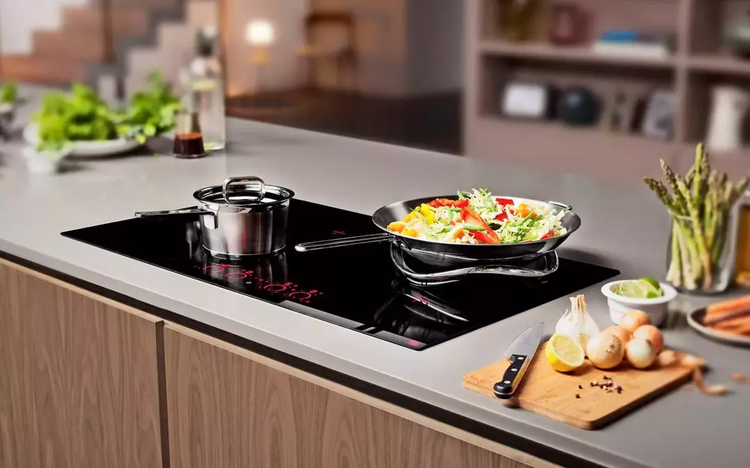 Photo of steel cookware on an induction stove