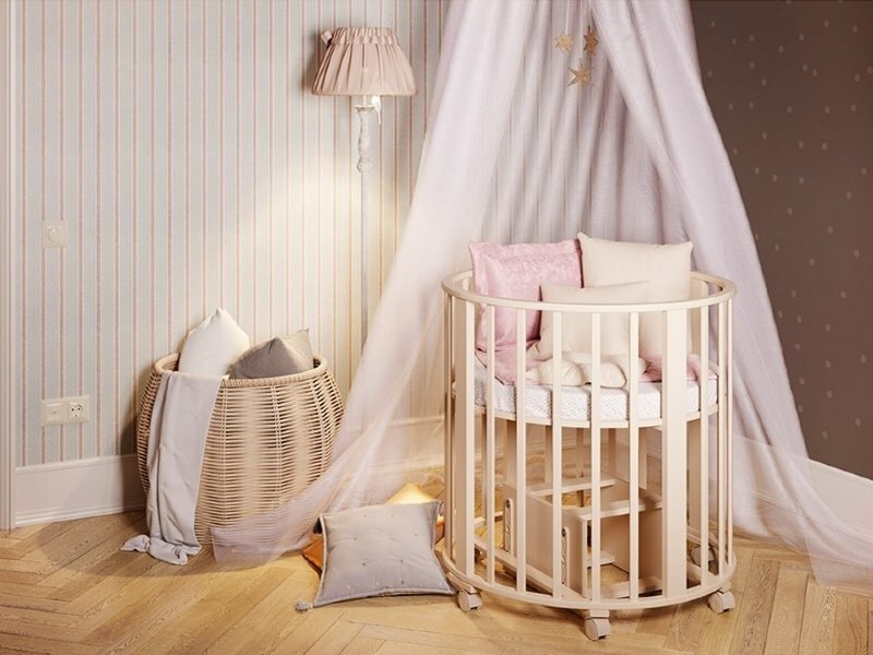 Oval transformerande säng för en nyfödd