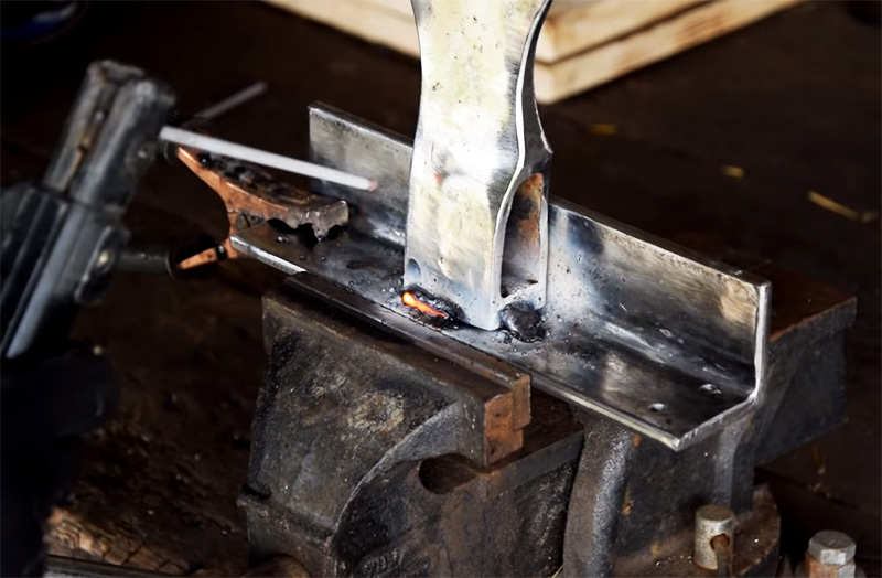 The ax is welded to a base made from a corner